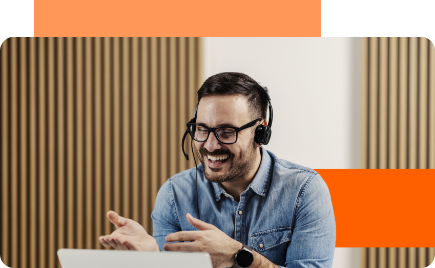 man with glasses talking on headset while smiling